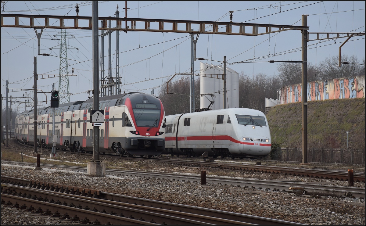 Begegnung des Kiss RABe 511 021 mit dem ICE 401 080 in Pratteln. Februar 2017.