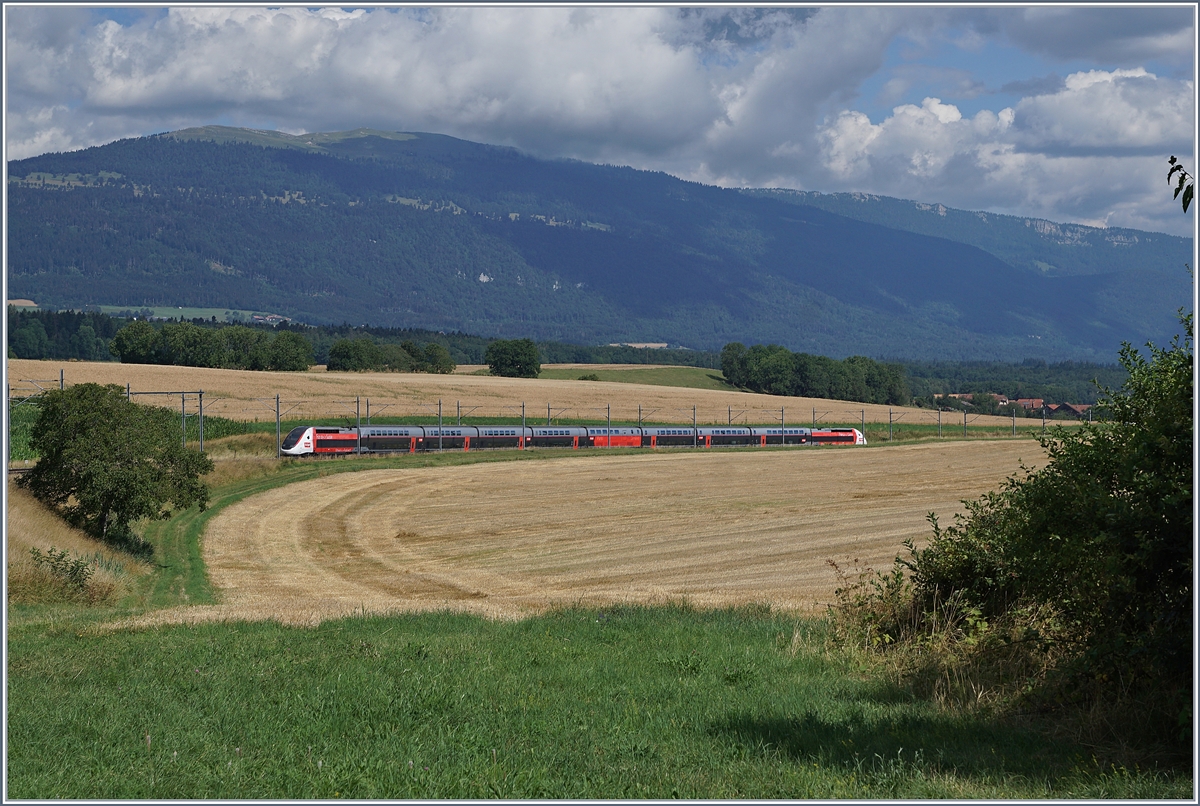 Der TGV Lyria 9261 von Paris Gare de Lyon nach Lausanne oberhalb von Arnex auf der Fahrt durch die hügligen Jurasüdfuss Landschaft. 

25. Juli 2020