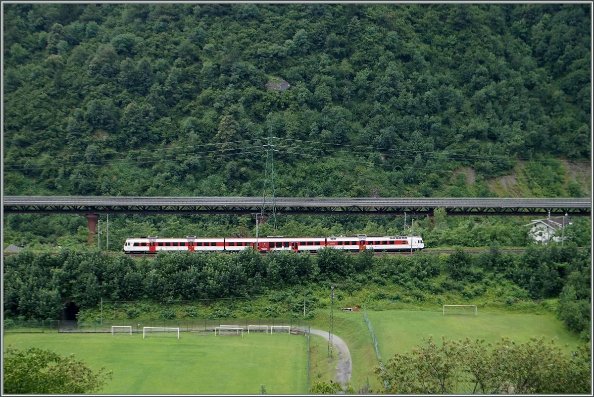 Die Südrampe der Simplonstgrecke verläuft oft in Tunnel oder Galerien; nur bei Varzo, wo sich das Tal etwas weitet und dann von Preglia bis Domosossla, gibt es einig Möglichkeiten die Strecke zu fotografieren, wobei zu beachten ist, dass im Sommer die Vegetation die Sicht einschränkt. 
Hier ist von Ort Varzo aus fotogarfiert ein  Walliser Domino  zu sehen, der als IR 3317 von Domodossola nach Brig unterwegs ist.
2. Juli 2014