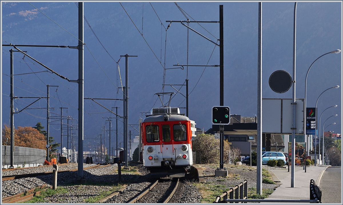 Für einige Zeit wurde die Strecke von Martiny nach Châtelard (TMC / MC) infolge Bauarbeiten mit Busen bedient. Da die Strassenführung erheblich von der Streckenführung der Bahn abweicht, wurde zwischen Martigny und Vernayaz MC ein stündlicher Pendelbetrieb eingerichtet, welcher nach meinem Augenschien mit einem BDeh 4/4 abgewickelt wurde. Am letzten Tag der Bauarbeiten machte ich mich endlich auf, um die sonst im Regelverkehr eher selten anzutreffenden Triebwagen zu fotografieren. Dies erwies sich als weit schwieriger als gedacht, da die Strecke auf der Süd- und Sonnen- Seite durchgehend von der Strasse mit Leitplanken begleitet wird und zudem die  Sonnenseite  in Anbetracht der hohen Berge auf dem überwiegenden Teil der Strecke im Schatten liegt. Also begnügte ich mich Aufnahmen in Vernayaz MC und bei der ehemaligen Haltestelle La Bâtiaz (EH). Im Bild ist der TMR / MC BDeh 4/4 N° 8 auf der Fahrt nach Martigny, kurz nach der ehemaligen Haltestelle La Bâtiaz zu sehen. Links im Bild erkennt man die erwähnte  schattigen Sonnenseite  mit der Strasse nach Vernayaz. 18. Nov. 2018