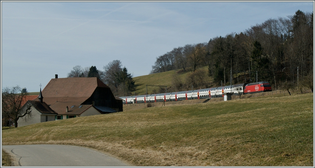 Zwischen Cottens und Neyruz f�hrt eine Re 460 mit einenm IC unter den alten, filigranen Fahrleitungsmasten St. Gallen entgegen. 12. M�rz 2012
