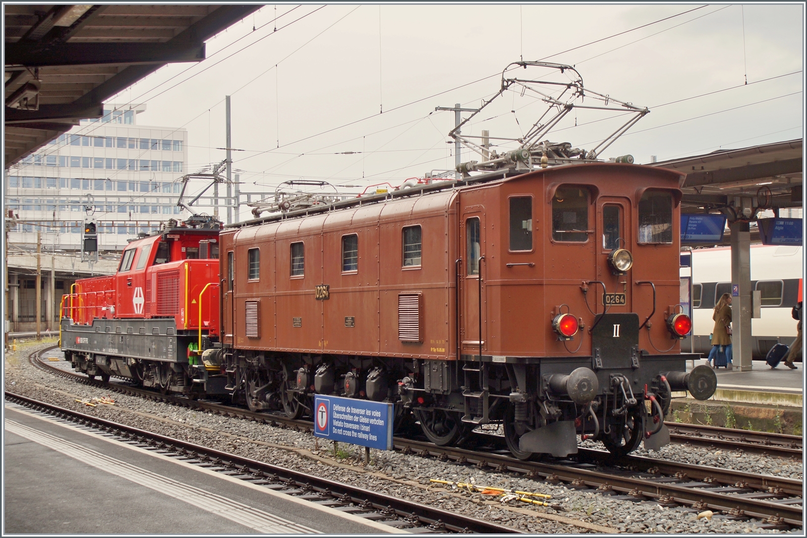 Die SBB Historic Ae 3/6 III 10264 schiebt in Lausanne ein mächtiges ETCS Gerät in Form einer Aem 940 vor sich her. Die Lok ist wohl auf der Rückfahrt vom Dépôt Fest in Olten nach  St-Maurice. Bilder ohne das störende  Überschreiten der Geleise verboten  - Schildes folgen.

28. August 2023